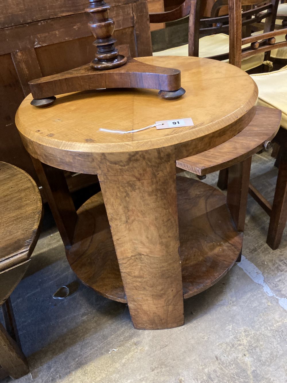 An Art Deco maple and walnut circular two tier table, fitted slides, diameter 60cm, height 62cm together with a Victorian rosewood pole